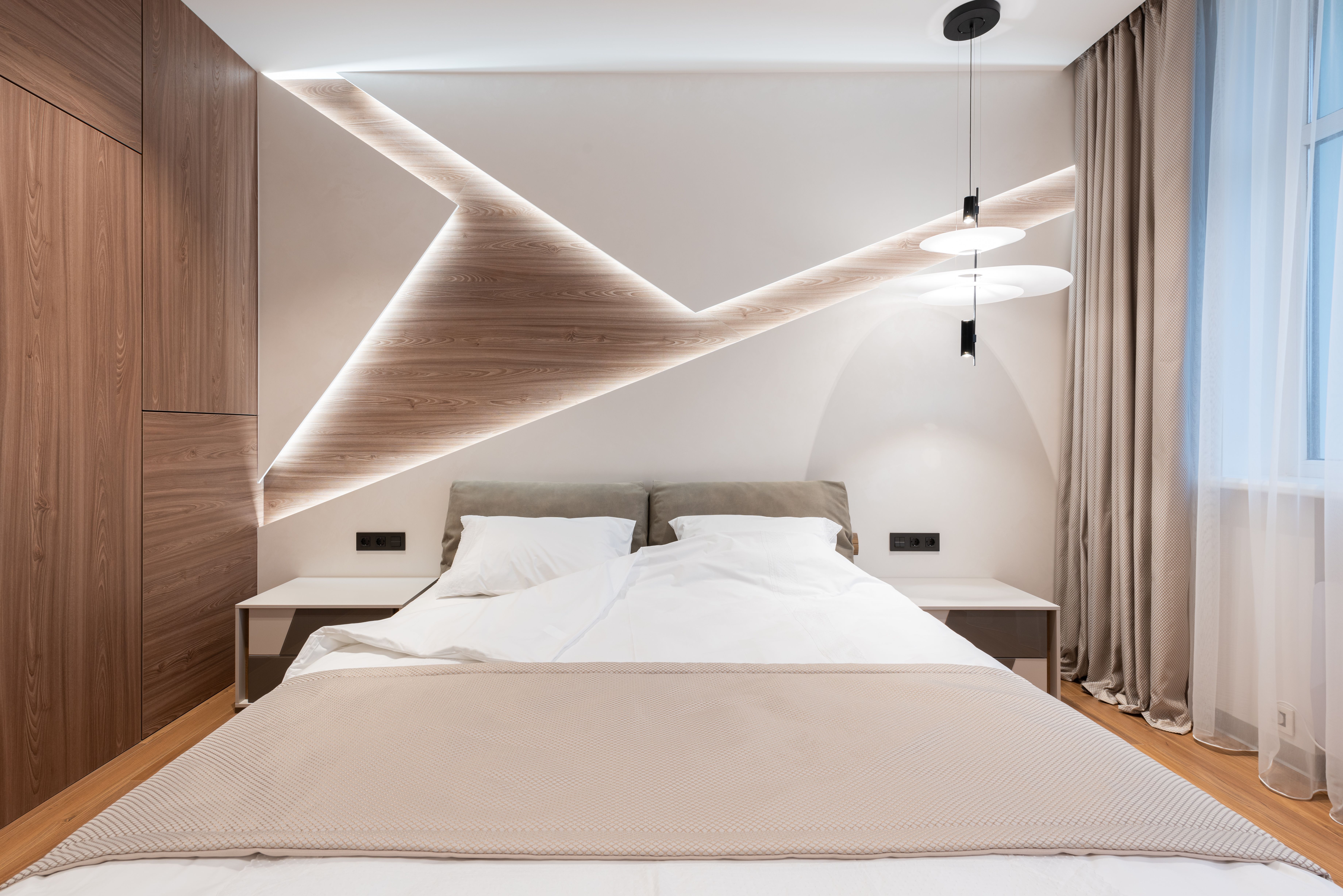 Bright hotel room with a double bed, illustrative stock photograph